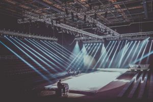 An expansive indoor stage with dramatic lighting setup, ready for a performance or event.